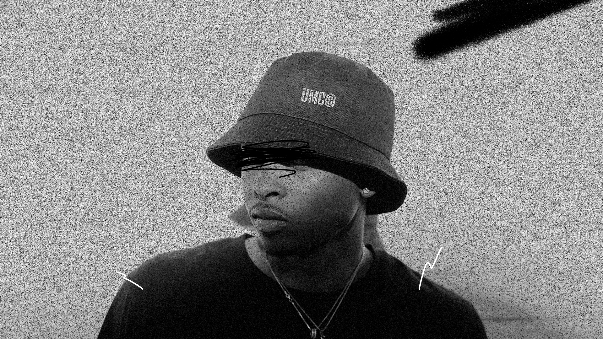 Man wearing a cap featuring the Uncommon Minds Collective (UMC) logo, designed for the accessories category. Trendy and stylish headwear to complement any outfit. Shop UMC for fashionable caps and accessories.