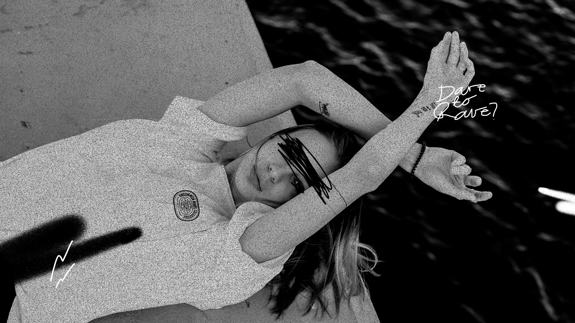 Woman laying on her back, wearing a white t-shirt by Uncommon Minds Collective (UMC). Comfortable and relaxed streetwear style for women. Shop UMC for minimalist fashion and everyday essentials.